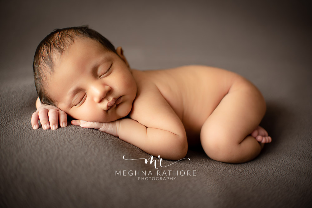 24 days old newborn baby boy posing adorably in professional photoshoot set up at Meghna Rathore photography in gurgaun, new delhi and noida