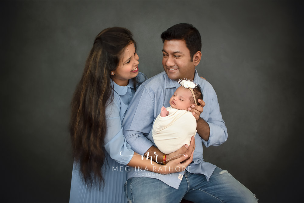 24 days old newborn girl child posing with family best indoor photo studio at meghna rathore photography in gurgaoun